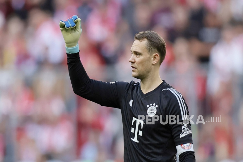 Manuel Neuer mengenakan seragam Bayern Munchen sambil memegang sarung tangan kiper